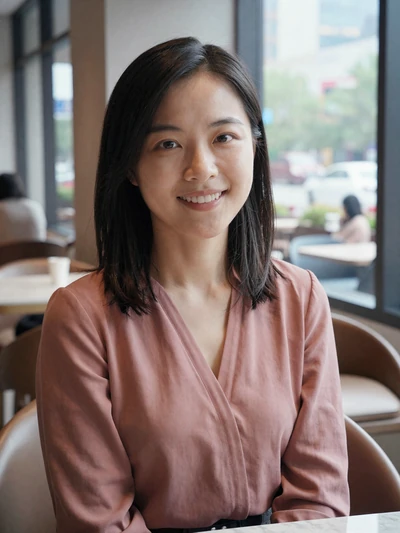 Mei Lin, 29, verified Chinese woman in a rose blouse at a Shanghai cafe - safe online dating profile