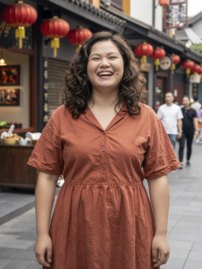 Xiao Wen, 27, verified Chinese woman in terracotta dress on a lantern-lit Chengdu street - avoid dating scams